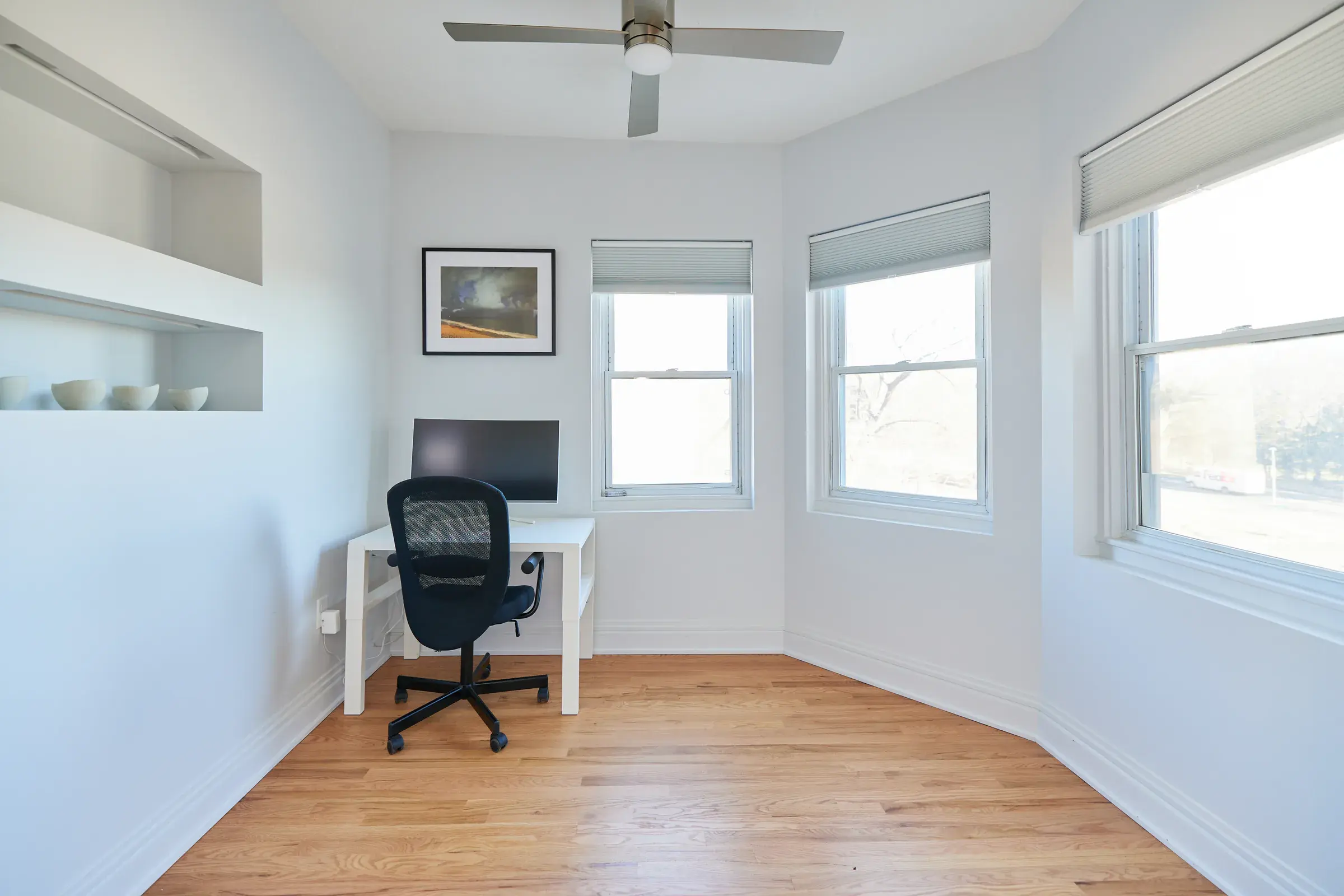 Clean natural hardwood floors in a bright apartment office