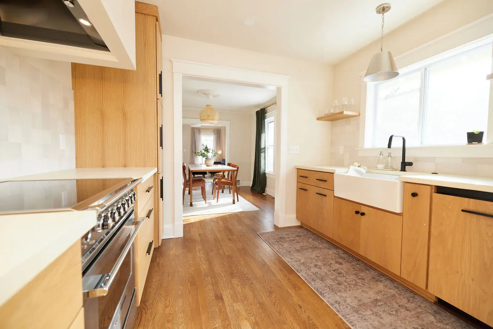 Restored hardwood flooring through a remodeled galley kitchen